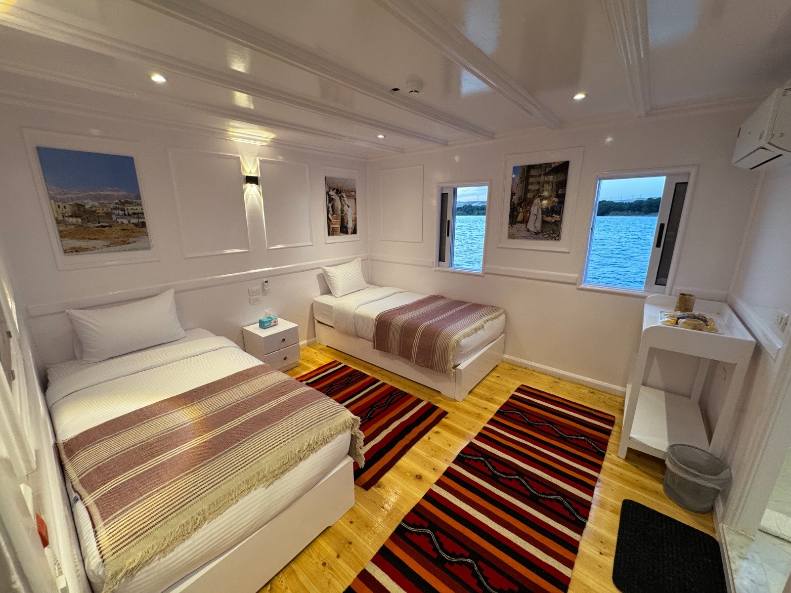 Spacious Deluxe Twin Cabin on Soul of the Nile Dahabiya featuring modern decor and Nile view window